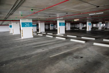 Öğleden sonra içi boş uzay parkı. Kapalı otopark. Otoparkın içinde, içinde araba ve boş otopark var. Daire ya da mağazada boş bir otopark..
