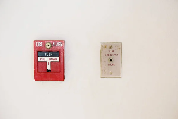 fire alarm box on cement wall for warning and security system in the condominium place. standard safety in the resident, shopping mall and public place concept. image for copy space, background.