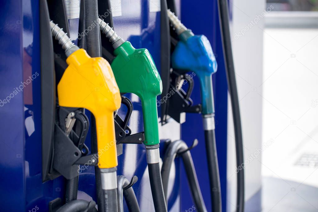 Colorful Petrol pump filling nozzles isolated on white background , Gas station in a service in warm sunset.Head fuel vehicle refueling facility in asia