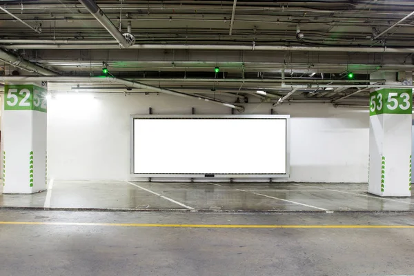 parking garage underground interior with blank billboard.Empty space car park interior at night.Indoor parking lot.interior of parking garage with car and vacant parking lot in building.