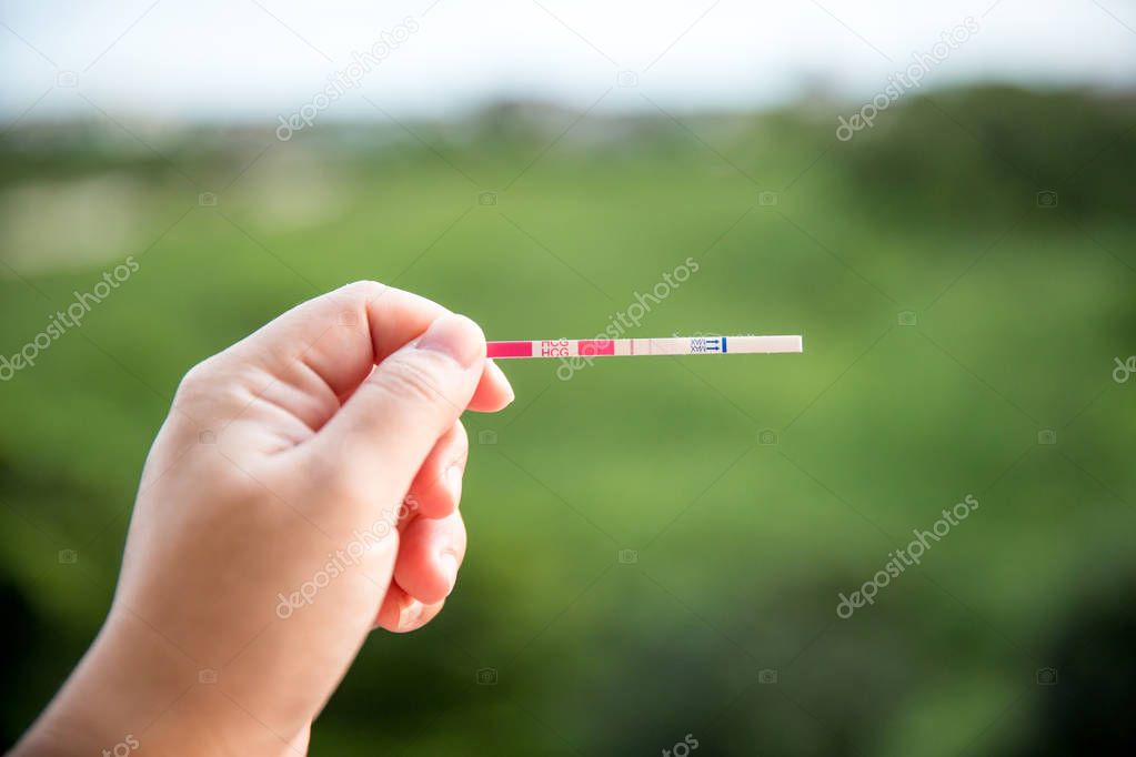 Positive pregnancy test on strip. baby coming soon concept.
