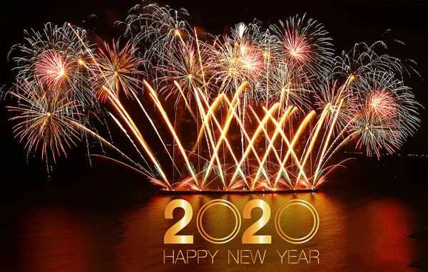 Fireworks with in a holiday events.New Year fireworks on the beach. Cheerful fireworks display in the city, with lots of colorful bangs rising high into the night sky. Happy New Year 2020.