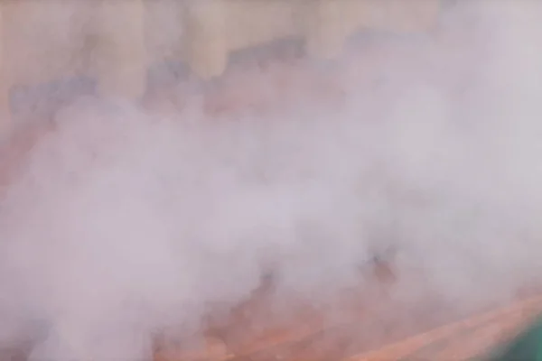 Photo of  smoke created with an electric fog machine on an empty stage. Smoke machine on a stage .