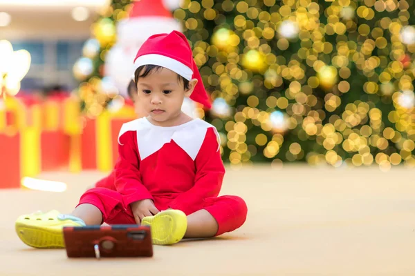 kid playing with a tech device alone. Cute Asian boy looking at the smart phone screen. Children Addicted to Smartphone or game concept. baby playing with a smartphone - Technology addiction.