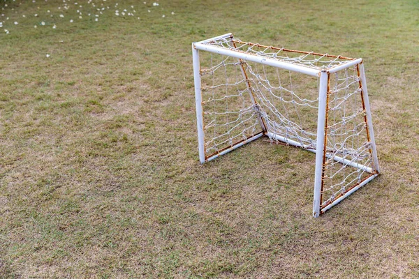 Mini Soccer goal on the green grass field. Outdoors mini football court. Mini football goal.