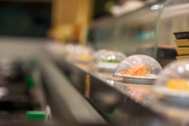 Japonya restoran suşi konveyör veya kemer büfesi. bulanık arka plan ile japonya restoranda kemer suşi.
