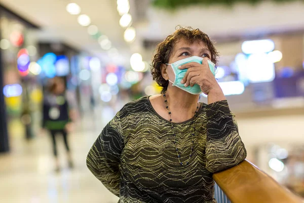 Old asian woman in a mask for COVID-19, for protection against the crown virus. Asian senior woman with protective mask because dirty air smog, PM2.5. Coronavirus old woman walking with surgical mask