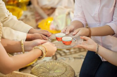 hands of a young couple praying at the table