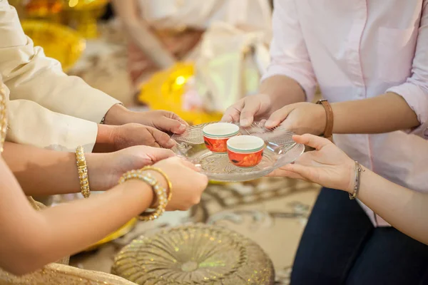 hands of a young couple praying at the table