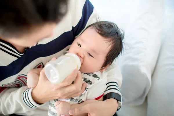 Asian Baby Boy Feeding Her Infant Milk Bottle His Little — стоковое фото