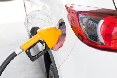 close up of a hand of a man refueling a gas pump