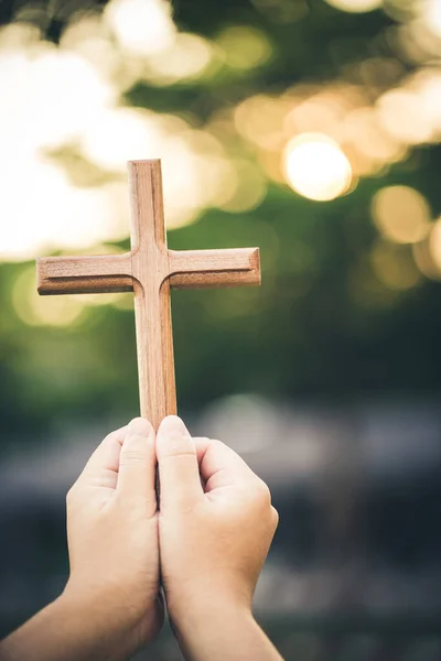 Hand Holding Wooden Cross Blurred Background - Stock-foto