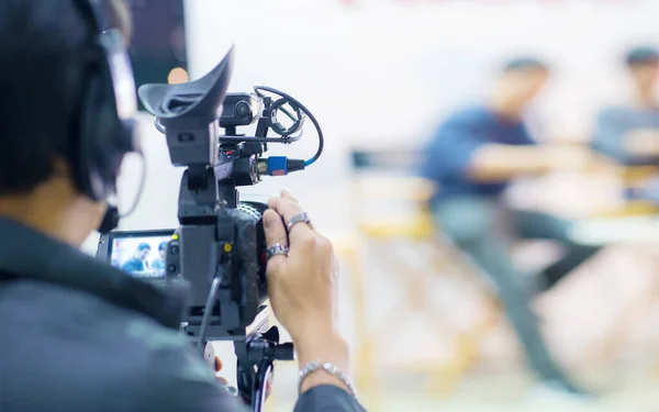 professional photographer recording video conference with blurred background