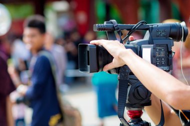 professional reporter recording video conference with a microphone