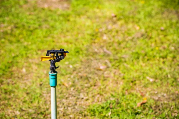 Man Watering Lawn Mower Green Grass — Stock Photo, Image