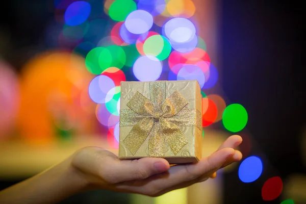 christmas gift in hand on blurred background
