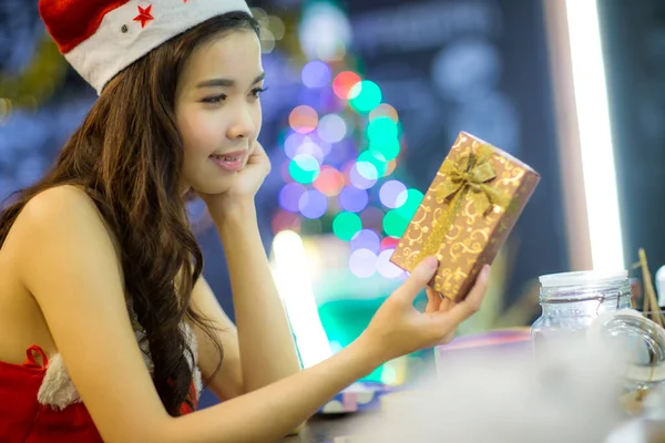 beautiful young woman with gift box and christmas gifts