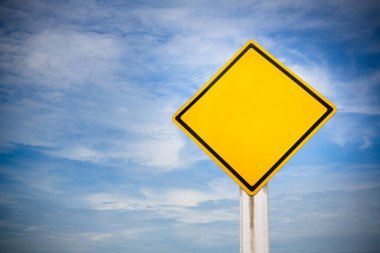 yellow road sign on blue sky background