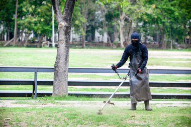 man with a sword and a white helmet on a green lawn
