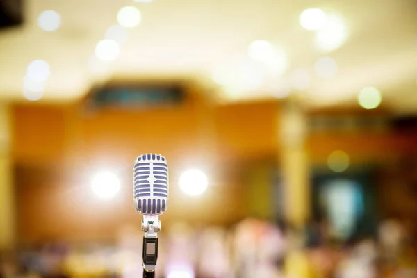 microphone vintage style in concert hall or conference and meeting room. soft and blur style for background. Microphone over the Abstract blurred photo of conference hall