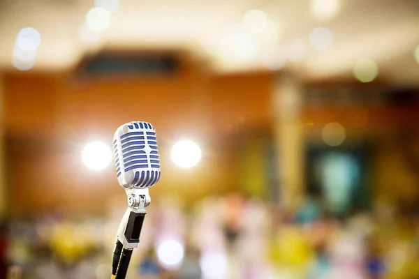 microphone vintage style in concert hall or conference and meeting room. soft and blur style for background. Microphone over the Abstract blurred photo of conference hall ,seminar and meeting room.