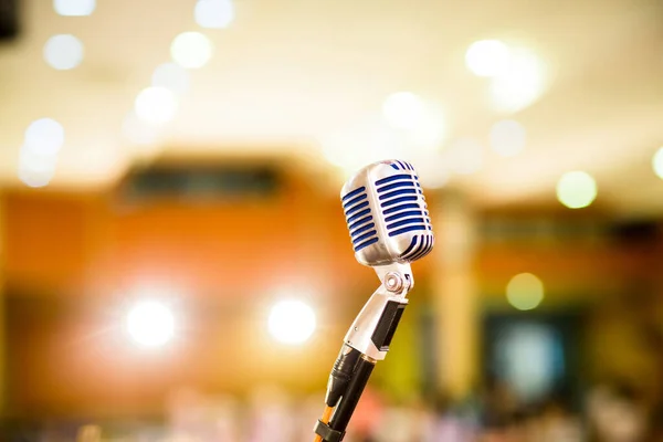 microphone vintage style in concert hall or conference and meeting room. soft and blur style for background. Microphone over the Abstract blurred photo of conference hall ,seminar and meeting room.