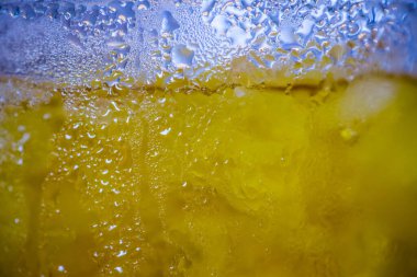 Beyaz zemin üzerinde kabarcıklar olan taze sarı su