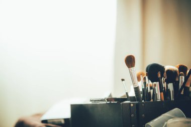 makeup brushes and accessories on white background