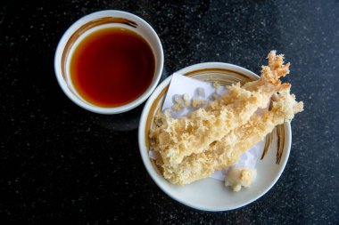 Bal ve bir fincan çay, siyah arka planda.