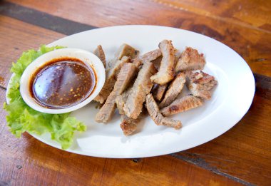 Dilimlenmiş biftek ve yeşil yapraklı salata. Kırsal tabaklarda salata. Orta pişmiş ızgara biftek ve gri taşlı arka planda sağlıklı salata.