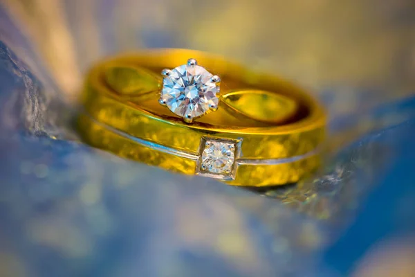 gold ring with diamond and diamonds on a white background