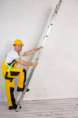 A professional builder with a ladder, compact and ready to work at any time. clipart