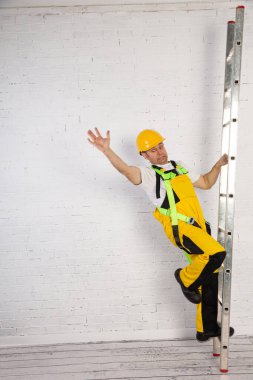Irresponsible use of a ladder during construction works.