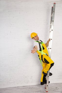 Irresponsible use of a ladder during construction works.