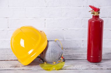 A protective helmet and dust mask as well as a fire extinguisher are necessary for any construction work.