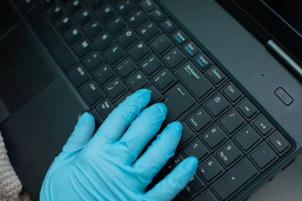 個人感染時には ゴム手袋などの特別な注意が必要です 安全のためのゴム手袋のティーンエイジャーによって使用されるラップトップキーボード — ストック写真