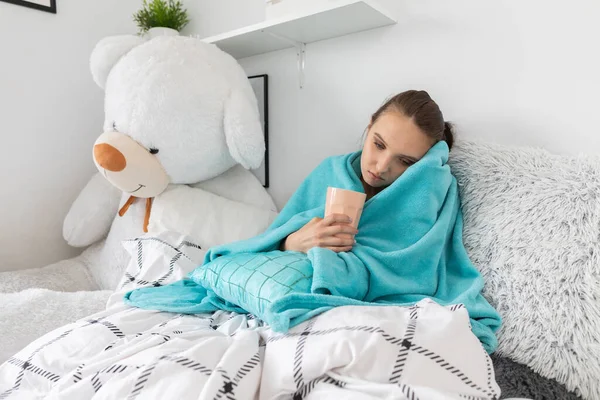 The young girl drinks a special hot infusion of herbs to return to full health faster.