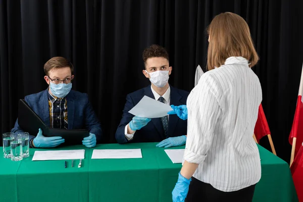 Genç bir adam ve genç adam bir masada oturmuş seçmenleri bekliyorlar..