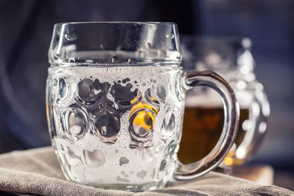 Beer. Two cold beers. Draft beer. Draft ale. Golden beer. Golden ale. Two gold beer with froth on top. Draft cold beer in glass jars in home pub hotel or restaurant. Empty beer glass. Still life — Stock Photo, Image