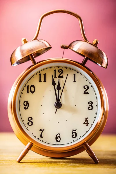 Ρετρό ρολόι-ξυπνητήρι με δύο λεπτά πριν από τα μεσάνυχτα. Φιλτραρισμένη φωτογραφία σε ζωηρά χρώματα 50s σε 60s. Ροζ φόντο — Φωτογραφία Αρχείου
