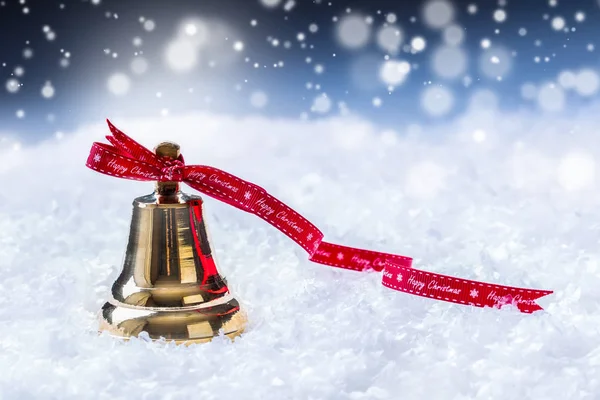 Christmas. Christmas bell with red ribbon and snowy background. Happy christmas text
