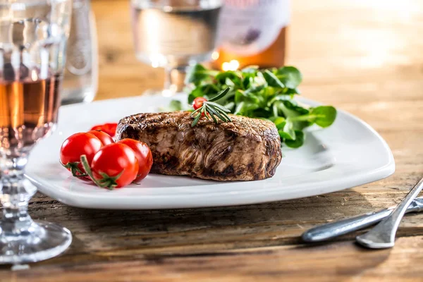 Carne de res. Carne de res jugosa. Filete gourmet con verduras y copa de vino rosa sobre mesa de madera —  Fotos de Stock