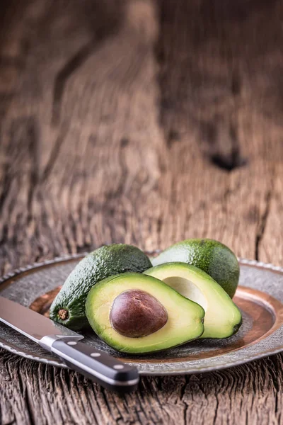 Avocado. Cut avocado on a oak wood background table. Selective focus — Stock Photo, Image