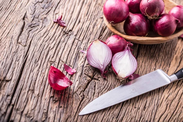 Onion. Red onions on very old oak wood board. Selective focus