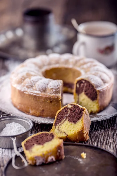 Marble cake.Easter Cake. Marble cake cup of coffee powder sugar and kitchen vintage utensil — Stock Photo, Image