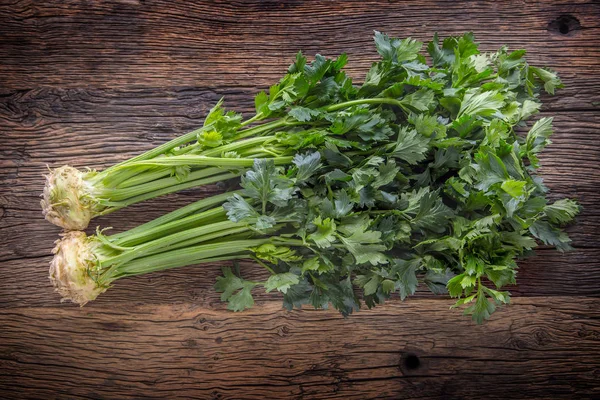 Celery root. Fresh celery root with leaf on rustic oak table