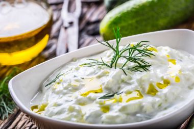 Tzatziki. Traditional greek dip sauce or dressing tzatziki prepared  with grated cucumber sour cream yogurt olive oil and fresh dill. Mediterranean cuisine clipart