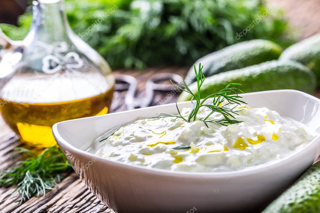 Tzatziki. Traditional greek dip sauce or dressing tzatziki prepared  with grated cucumber sour cream yogurt olive oil and fresh dill. Mediterranean cuisine