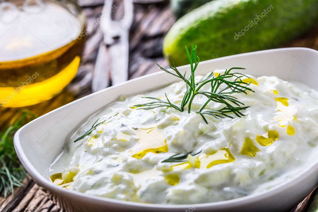 Tzatziki. Traditional greek dip sauce or dressing tzatziki prepared  with grated cucumber sour cream yogurt olive oil and fresh dill. Mediterranean cuisine