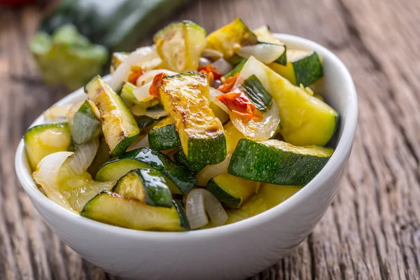 Zucchini. Zucchini salad. Grill Zucchini with onion an chili pepper. Salad with grill vegetable